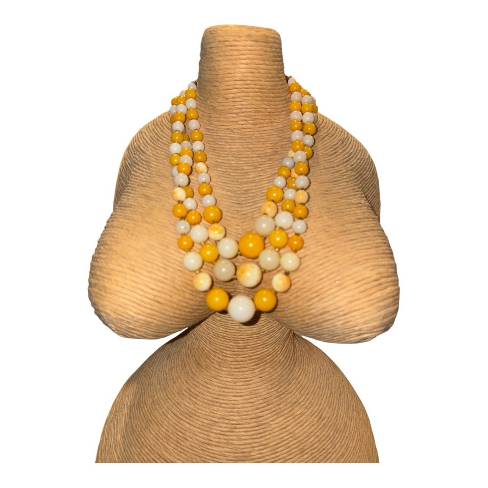 Gold & White Triple strand graduated beads marked Japan.